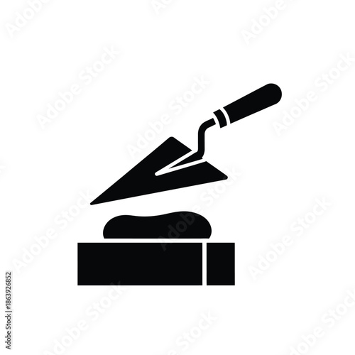 a simple black and white illustration depicts a trowel resting upon a mound of material set on a base