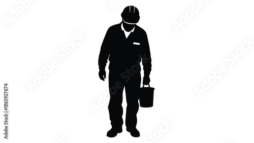 Silhouette of a construction worker or manual laborer standing thoughtfully while holding a small bucket