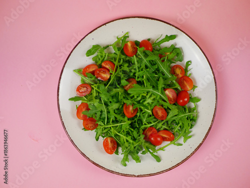 Wallpaper Mural Top view fresh arugula and cherry tomato salad arranged on a plate as a clean healthy step-by-step recipe illustration. Pro photo Torontodigital.ca