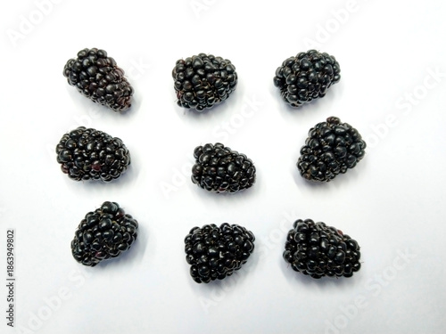 Freshly harvested blackberries on white background, showcasing nature's delicious bounty.