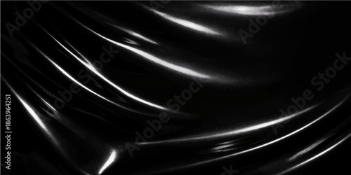 Smooth black satin and silk fabric background with luxury purple and blue light reflecting on the flowing textile material's soft wave pattern design