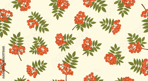 Autumn seamless pattern showing bright red rowan berries and green leaves scattered over a light cream colored surface.