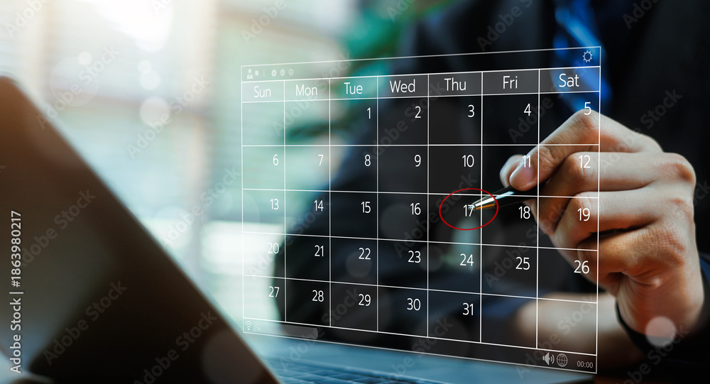 Fototapeta premium Business professional marking an important date on a digital calendar interface, representing planning, scheduling, deadline management, productivity, and modern corporate time management concepts.