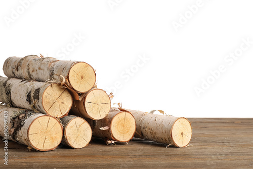 Stack of birch logs on wood...