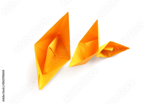 Orange paper boats on white...