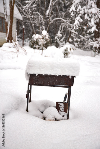 Wallpaper Mural Old metal barbecue grill covered with thick fresh snow in a winter garden. Abandoned outdoor BBQ in snowy backyard, symbol of cold season, quiet atmosphere and frozen countryside life Torontodigital.ca