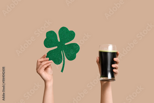 Hands with beer and clover ...