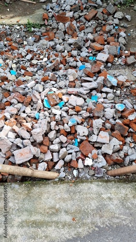 Construction Debris Pile with Broken Bricks and Concrete Fragments.