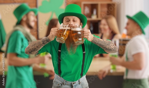 Bearded man with mugs of be...