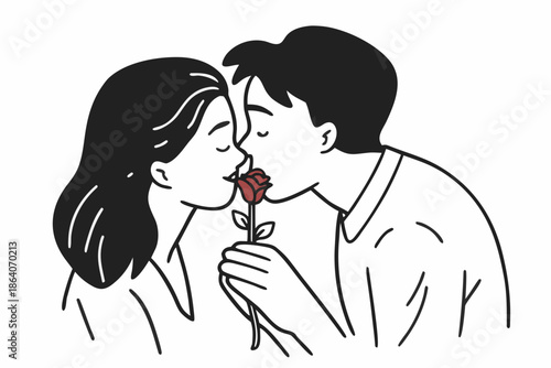 A young couple sharing a tender kiss with a rose between them