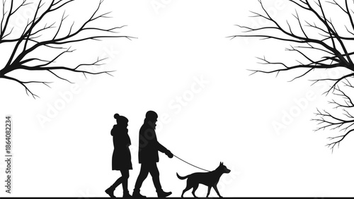 Couple walking dog together under bare trees