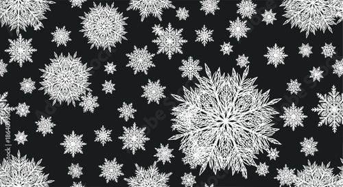 Dramatic winter background featuring a dense, overlapping pattern of intricate and detailed white snowflakes on a solid black backdrop.