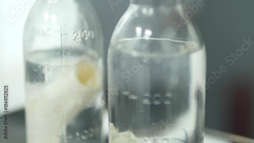 Laboratory. Medical research. Glass jar filled with clear liquid. Laboratory equipment. Science. Laboratory analysis of liquid in glass.