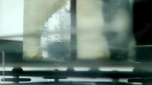 Laboratory. Medical research. Glass jar filled with clear liquid. Laboratory equipment. Science. Laboratory analysis of liquid in glass.