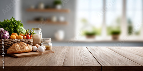 Fresh vegetables, eggs, and bread on wooden kitchen countertop with blurred modern kitchen background and natural light