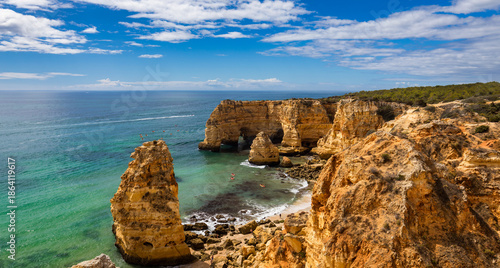 Natural caves at Marinha beach, Algarve Portugal. Rock cliff arches on Marinha beach and turquoise sea water on coast of Portugal in Algarve region.