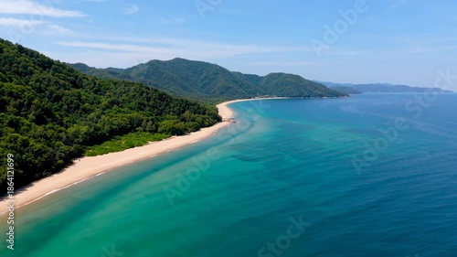 Wallpaper Mural Naturally inspired Aerial view of a pristine coastline with turquoise blue sea, golden sandy beach, and lush green hills under clear blue sky. Peaceful natural landscape with wide open space Torontodigital.ca