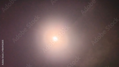 The Bright Full Moon rays glow through clouds in a blue sky backdrop with a light flare design for a star animation wallpaper short by smartphone 