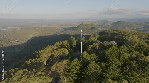 Scenic elevated views of the Australia flag on display at the Picnic Point public park area in Toowoomba with Table Top Mountain and the Bushland Reserve in the background, Queensland, Australia