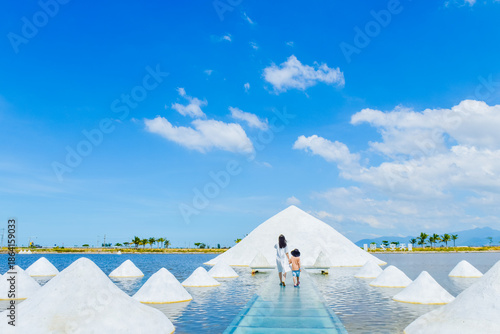 Photography Asian mother and kid enjoying the beautiful “Sky Mirror landscape of Yinggehai