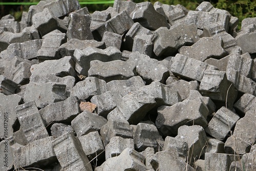 Close-up of grey bricks lying in a pile in the garden