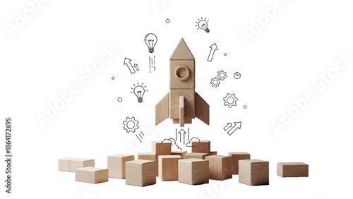 Wooden toy rocket ship launching upwards from foundation blocks symbolizing startup growth education and innovative business development concepts