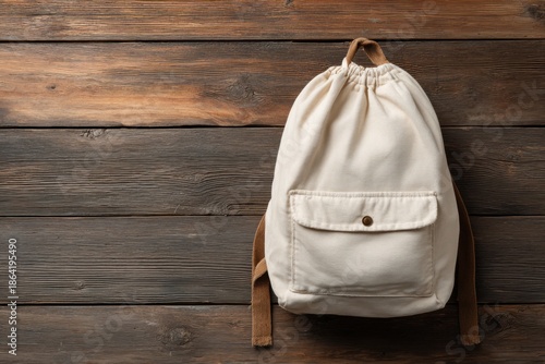 Cream-colored backpack on wooden surface