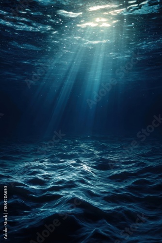 Underwater sunlight beams on dark ocean floor