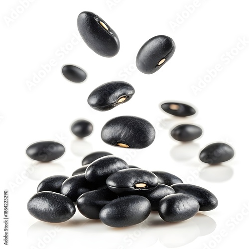 Black Beans Falling in Mid-Air on White Background