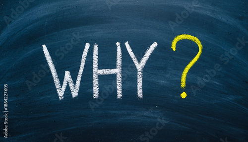White and yellow why question mark on a dark blue chalkboard background