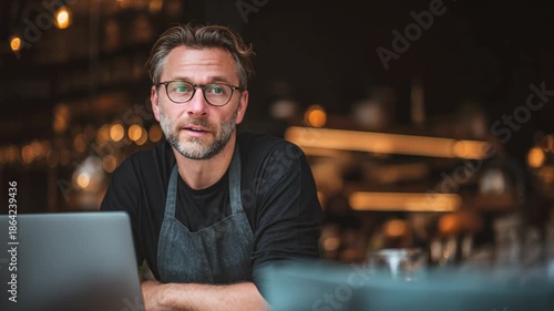 Chef planning menu on laptop