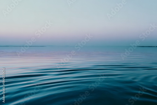 Serene water surface reflecting soft hues at blue hour, creating a tranquil atmosphere with gentle ripples and a peaceful ambiance, ideal for relaxation and meditation