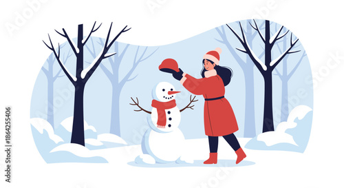 A young woman in a red coat and hat having fun building a snowman in a snowy forest on a beautiful winter day.
