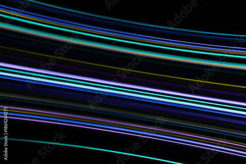 A long exposure photograph. Light painting photography, vibrant fairy lights in parallel lines and streaks against a black background