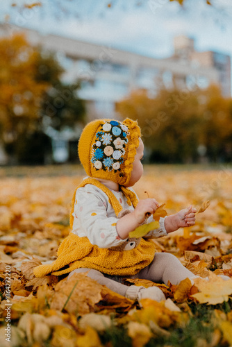 Baby Girl Rejoices, Smiles Sincerely Because Of Falling Autumn Leaves In Warm