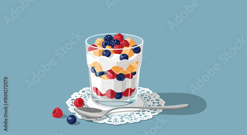 Healthy yogurt parfait with layers of cream, fresh raspberries, blueberries, and mango pieces served in a glass with a spoon.