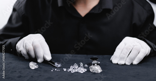 Photos Jeweler examining uncut diamonds with tools, closeup gemstone on mining factory