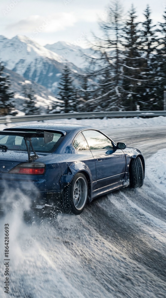 Naklejka premium A blue car drifts on a snowy road with mountains in the background, showcasing a dynamic winter driving scene.