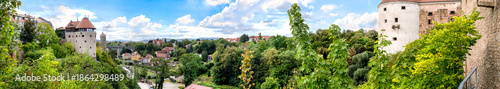 Bautzen, Germany - panoramic view of the old town and castle, wide view over river bank, towers, walls and wooded slopes under bright sky