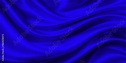 Smooth flowing blue silk and satin fabric background with soft waves of light and purple motion creating an abstract textile texture wallpaper design