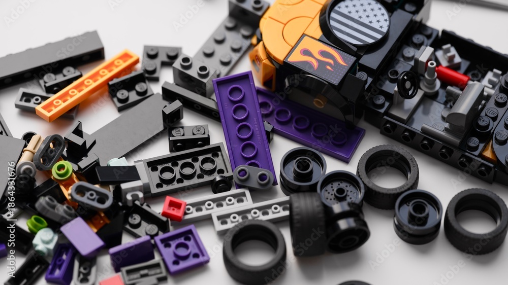 Fototapeta premium Tambov, Russian Federation - January 01, 2026 Lego Speed Champions Nascar Next Gen Chevrolet Camaro car kit build in progress with blocks, bricks and pieces on white table