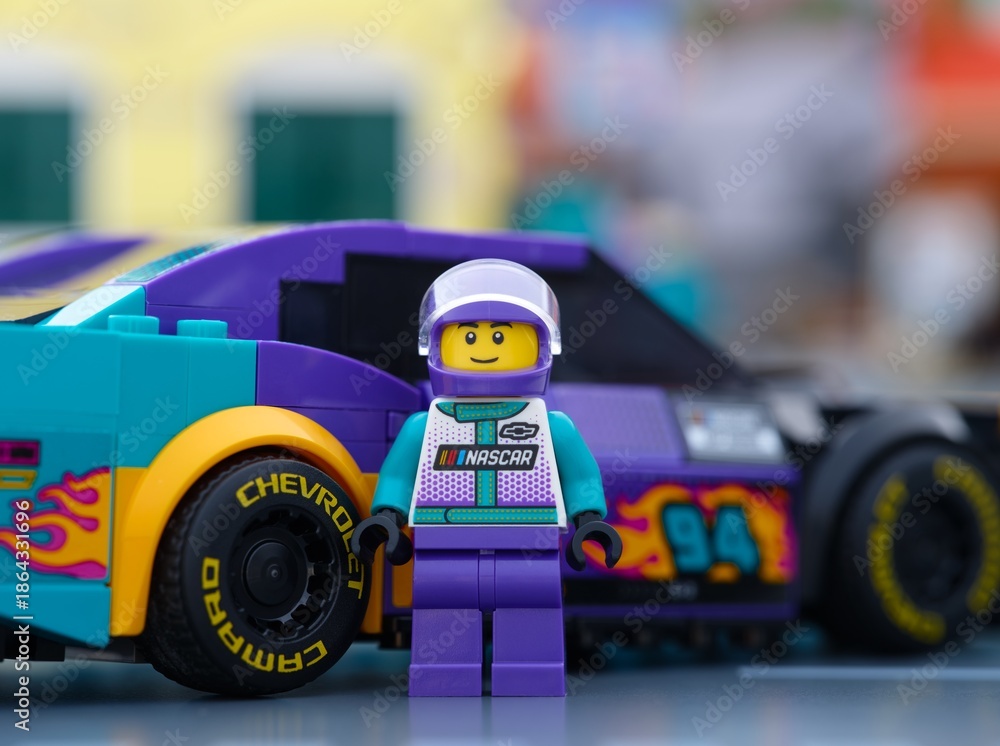 Fototapeta premium Tambov, Russian Federation - January 02, 2026 Lego NASCAR Next Gen Chevrolet Camaro ZL1 driver minifigure standing near his car. LEGO Speed Champions.