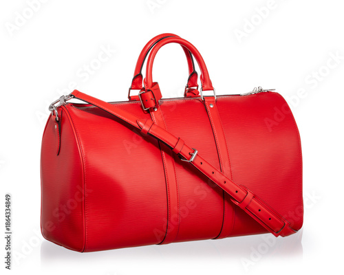 Large red travel bag with handles and a shoulder strap. Photographed on a white background with reflections.
