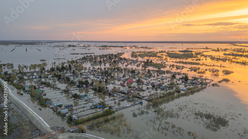 Aerial drone footage of a massive city flood with houses and streets submerged under water. Urban flooding caused by extreme weather and heavy rainfall, showing natural disaster impact on residential 