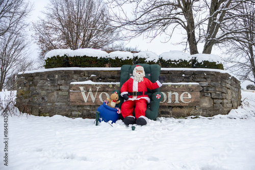 santa claus in front of greeting sign