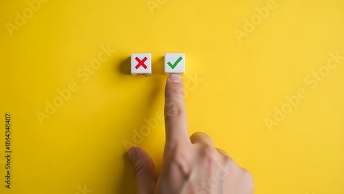 Hand choosing correct option with checkmark over incorrect x on yellow background