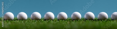 golf ball wide banner, row of nine white golf balls neatly aligned on vibrant green turf with a blurred blue sky in the background perfect for a golf challenge header