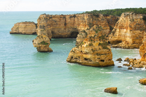 Praia da Marinha, beautiful beach Marinha in Algarve, Portugal. Navy Beach (Praia da Marinha) with flying seagulls over the beach, located on the Atlantic coast in Lagoa Municipality, Algarve.