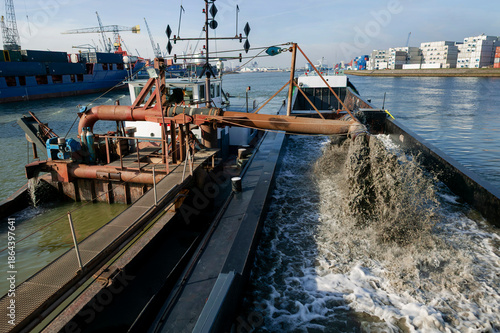 Fotografia Industrial dredging barge with crane and navigation signals working in harbor