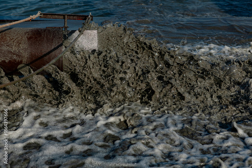 Tableau sur toile Close-up of liquified sand and sediment being pumped with foamy discharge